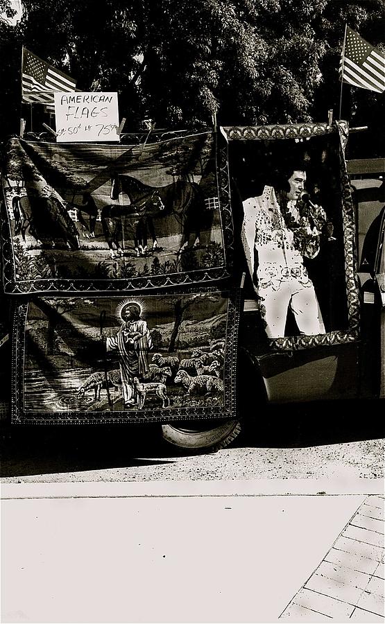Vendor selling American flags Elvis Presley and Jesus Christ tapestries Armory Park Tucson Arizona Photograph by David Lee Guss