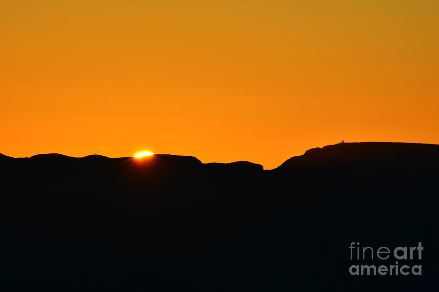 Vibrant Orange Sky Accompanies Sun Rising over Grand Canyon with Distant Watchtower Silhouetted Photograph by Shawn OBrien