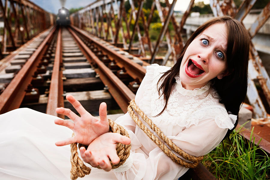 Victorian maiden tied to train tracks screams as engine approaches Photograph by RapidEye