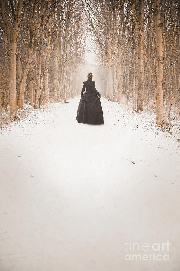 Victorian Woman Walking A Tree Lined Avenue In Snow Photograph by Lee Avison