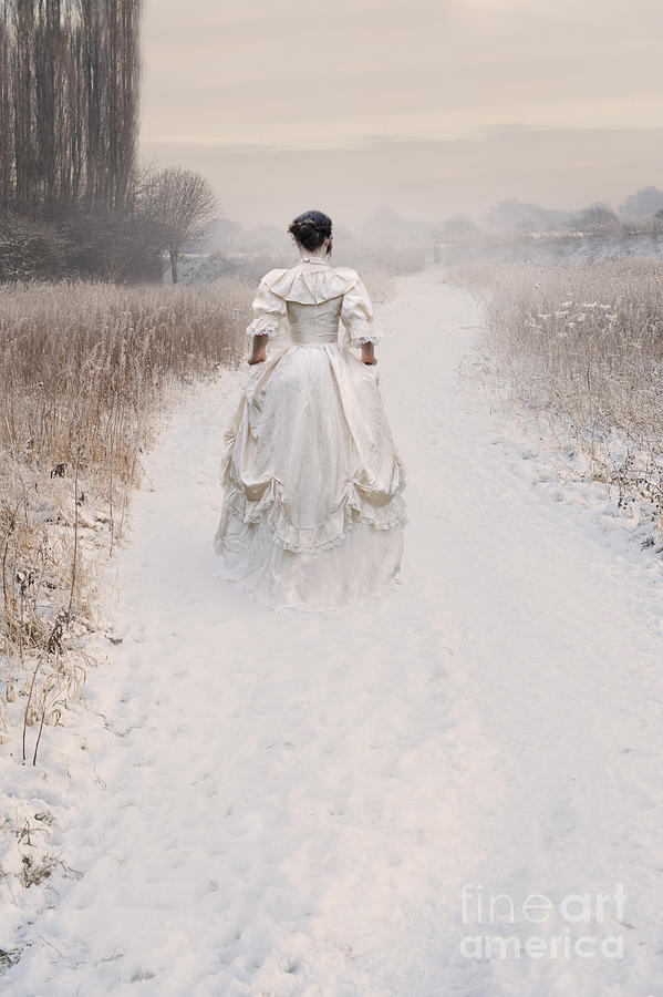 Victorian Woman Walking Through A Winter Meadow Photograph by Lee Avison