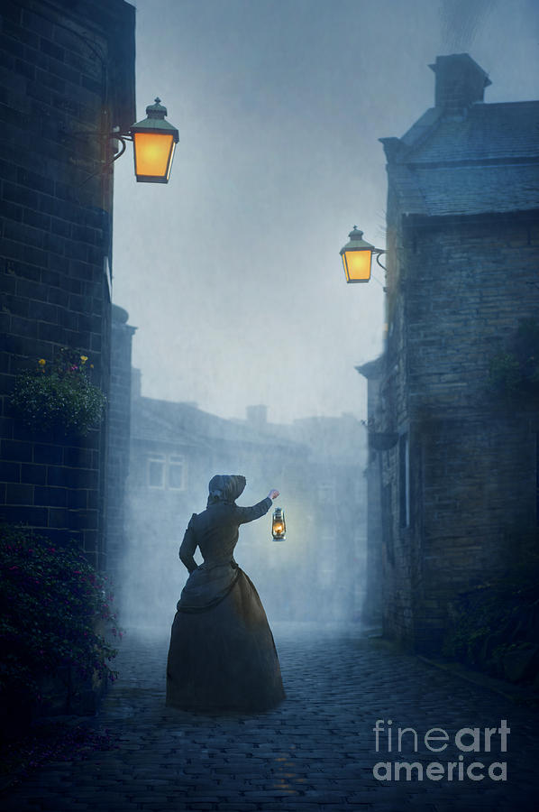 Victorian Woman With An Oil Lamp At Night On A Cobbled Street Photograph by Lee Avison