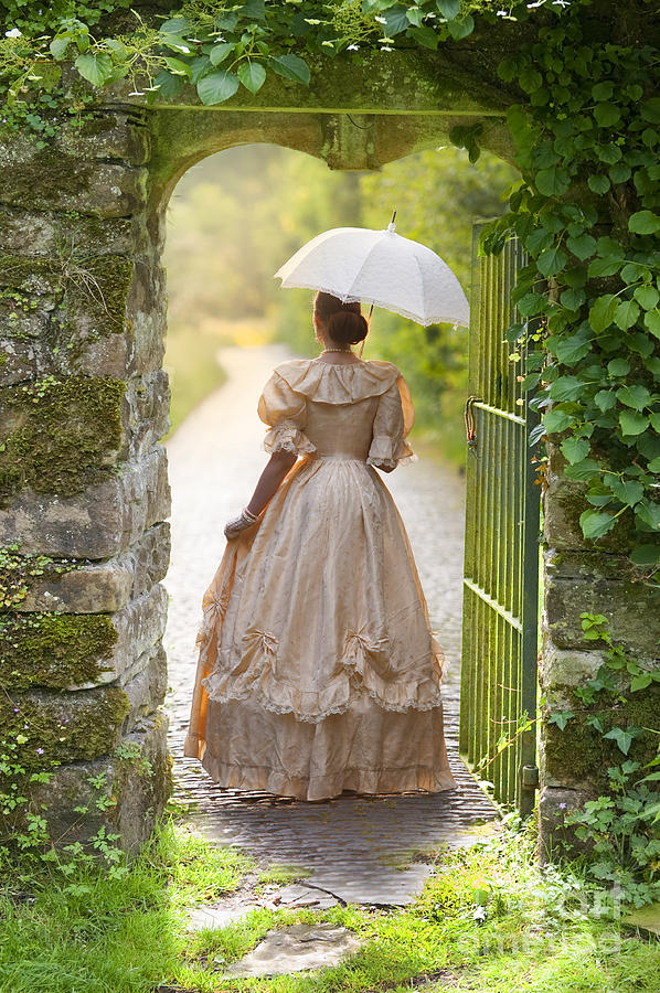 Victorian Woman With Parasol Walking Through A Pretty Gateway Photograph by Lee Avison