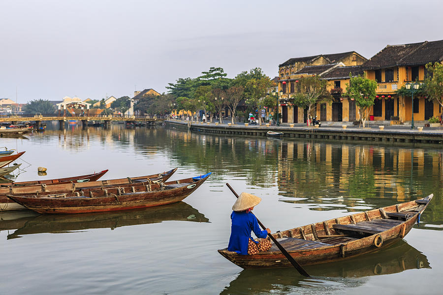 Vietnamese woman paddling in old town in Hoi An city, Vietnam Photograph by Hadynyah