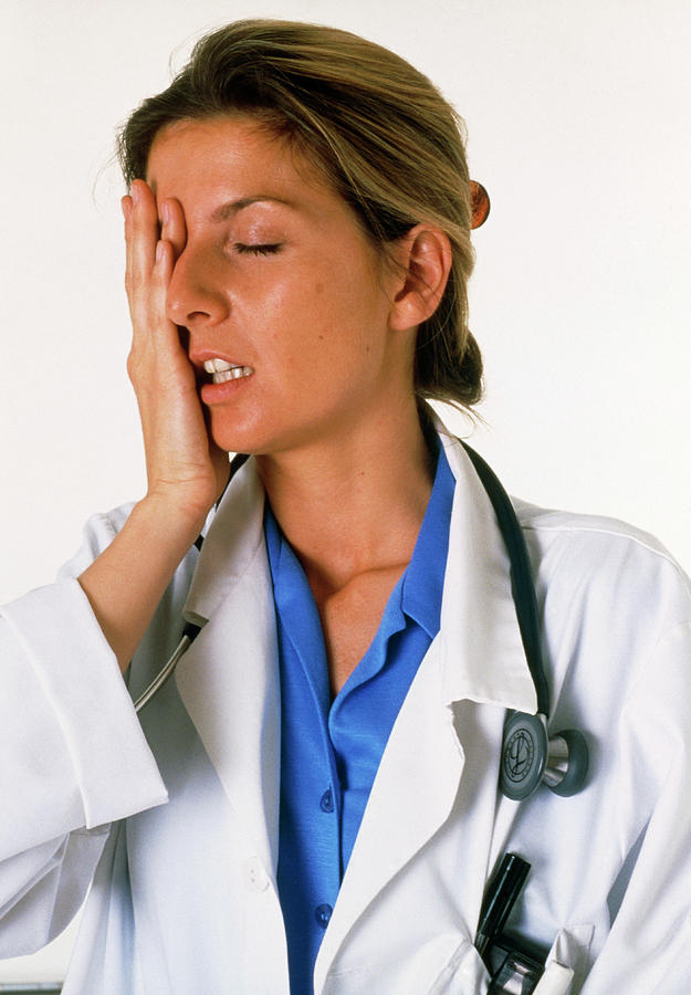 View Of A Tired And Stressed Female Doctor Photograph by Claire Paxton & Jacqui Farrow/science Photo Library