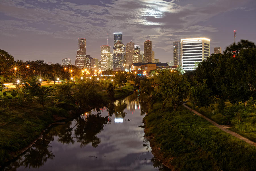 View of Downtown Houston Skyline and Buffalo Bayou Waterway with Super Moon Rising Behind the Clouds Photograph by Silvio Ligutti