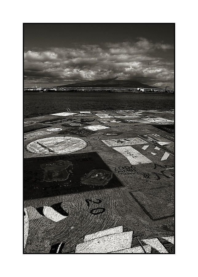 Black And White Photograph - View of Pico island from harbour wall Horta by Brian Grady