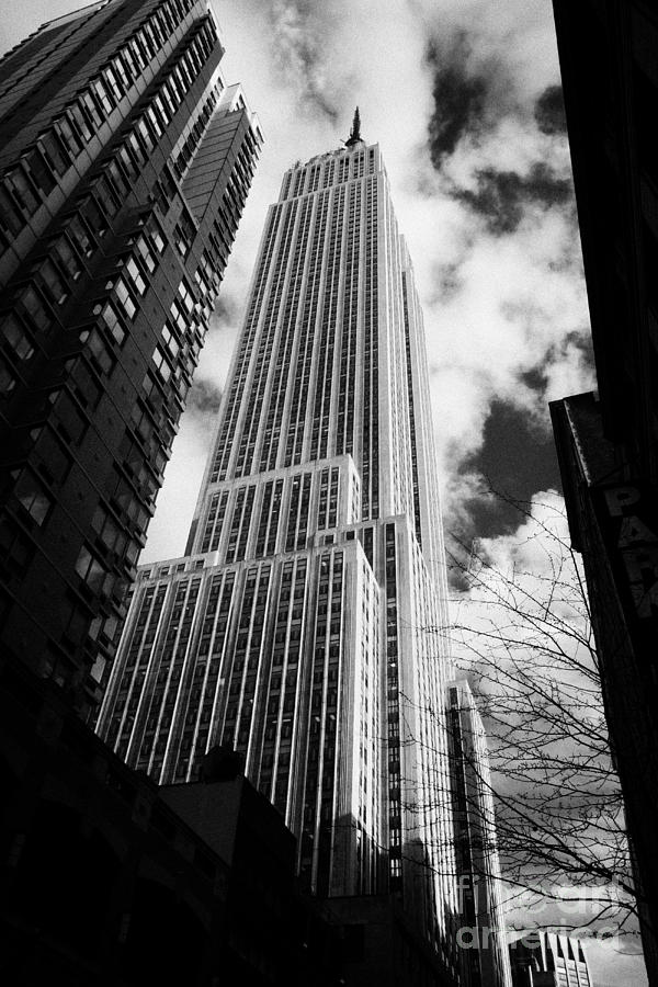 Winter Photograph - View of the empire state building and surrounding buildings and  cloudy sky from West 33rd Street ny by Joe Fox