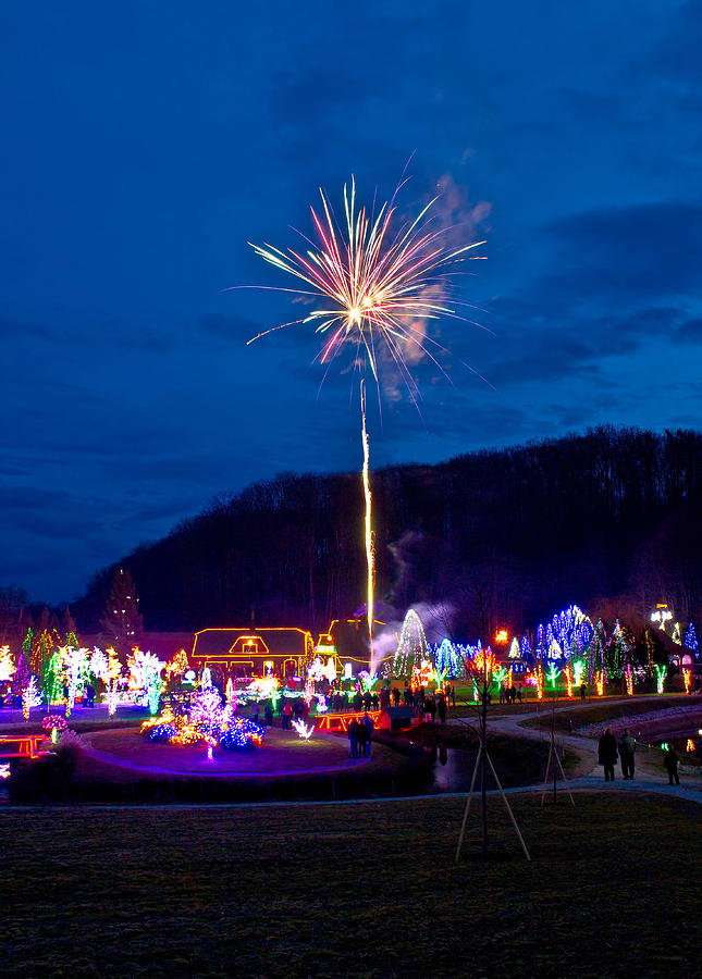 Village in Christmas lights fireworks Photograph by Brch Photography