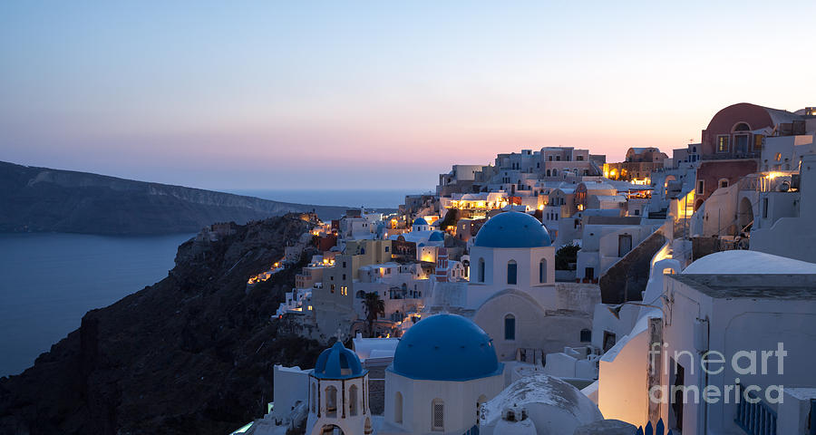 Greek Photograph - Village of Oia with blue domed churches at sunset by Matteo Colombo