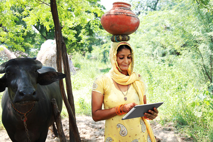 Village women using digital tablet Photograph by Pixelfusion3d