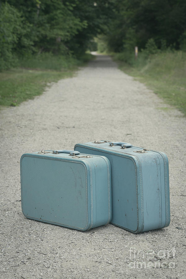 Vintage blue suitcases on a gravel road Photograph by Edward Fielding