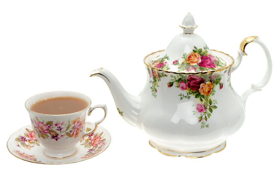 Vintage bone China teapot with a cup of tea. Photograph by Clubfoto