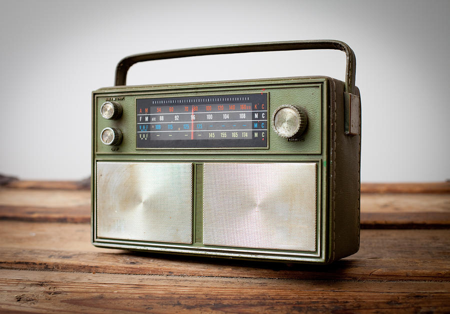 Vintage Green Portable Radio Sitting on Wood Table Photograph by Ideabug