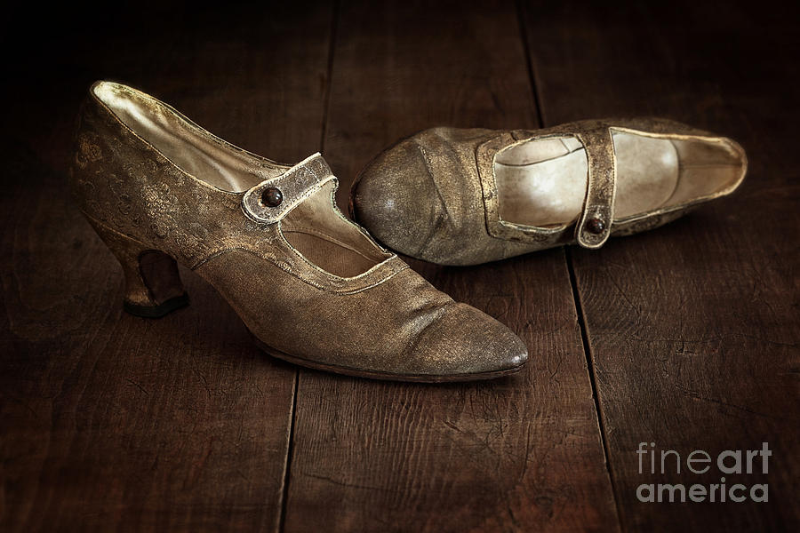 Vintage pair of ladies brocade shoes left on wooden floor Photograph by Sandra Cunningham