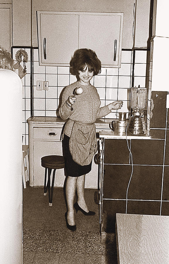 Vintage photo of a young woman in the kitchen Photograph by Shanina