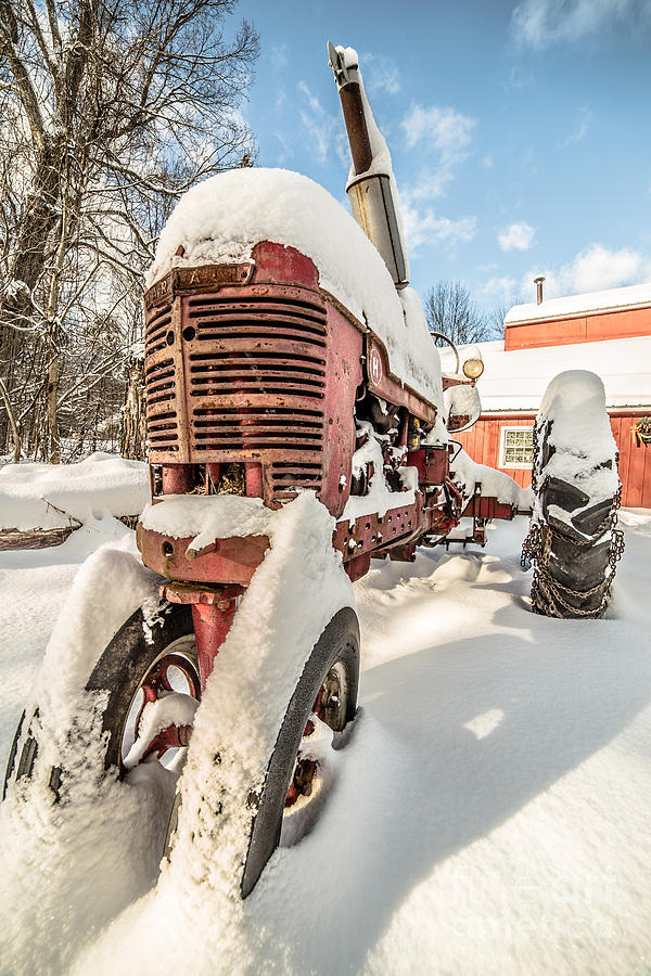 Vintage red Farmall Tractor in the Snow Photograph by Edward Fielding