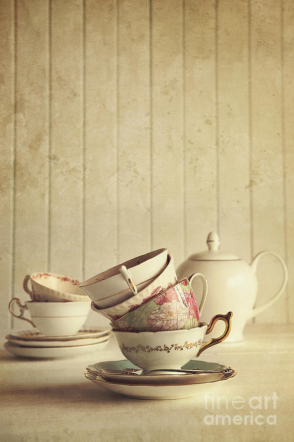Vintage tea cups stacked with wood background Photograph by Sandra Cunningham