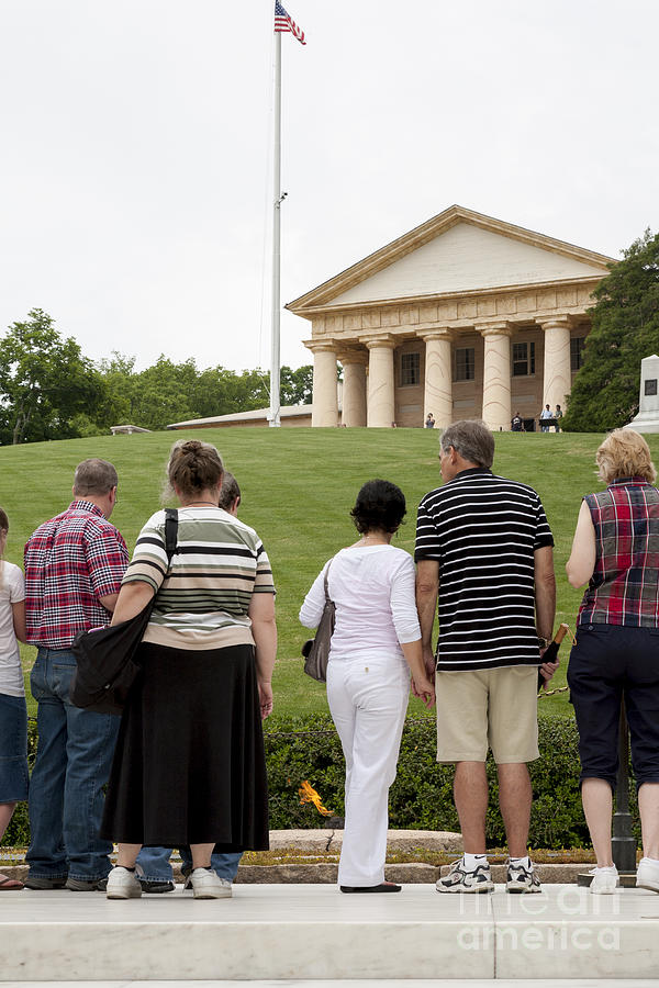 Visitors at the John F. Kennedy grave at Arlington National Cemetery with the Arlington House mansio Photograph by William Kuta
