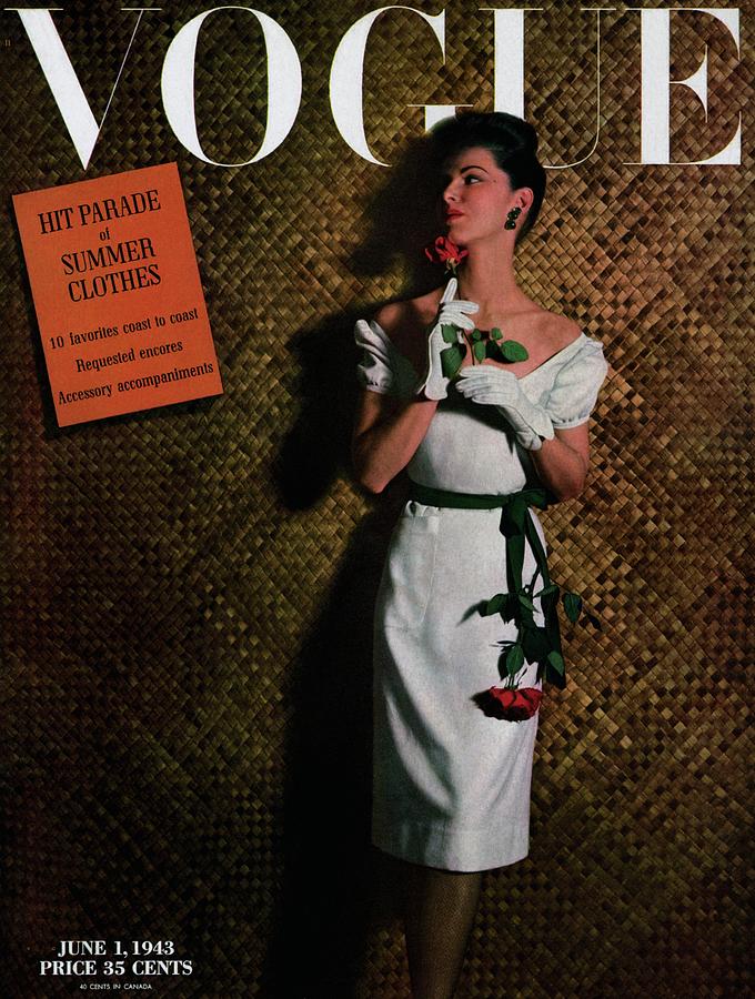 Vogue Cover Featuring A Model Holding A Rose Photograph by John Rawlings