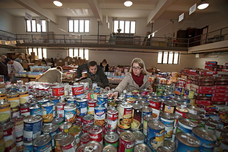 Thanksgiving Photograph - Volunteers At A Food Bank by Jim West