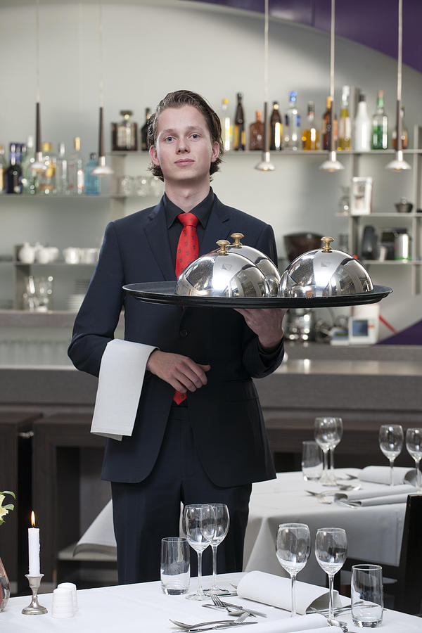 waiter carrying serving tray in restaurant XXXL image Photograph by Pidjoe