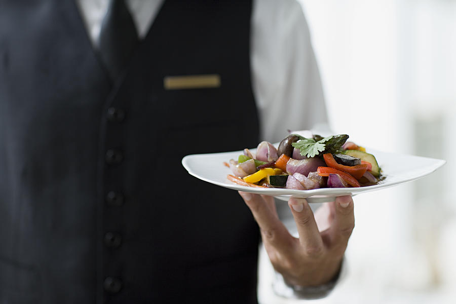 Waiter holding plate Photograph by Image Source