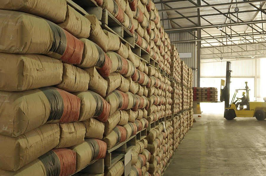 Warehouse full of sacks stacked from floor to ceiling Photograph by RicAguiar