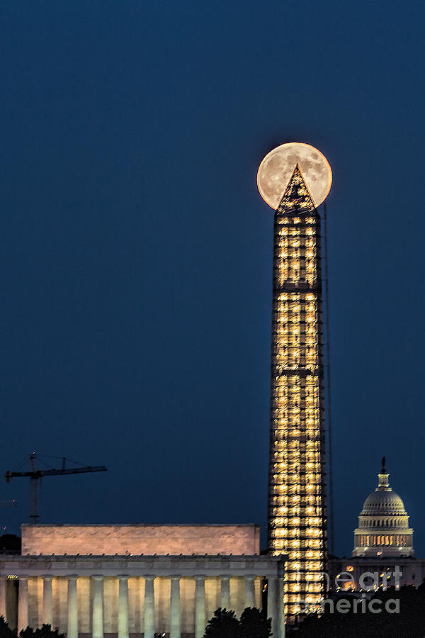 Washington Monument piercing the full moon Photograph by Izet Kapetanovic