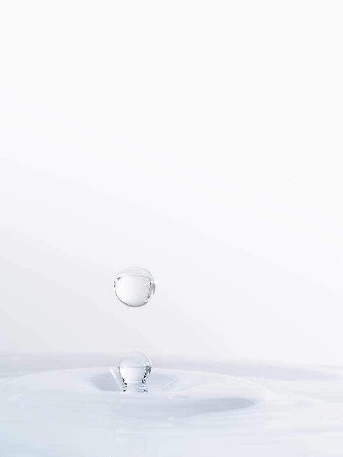 Water drop on having struck on a surface of transparent water Photograph by Jose A. Bernat Bacete