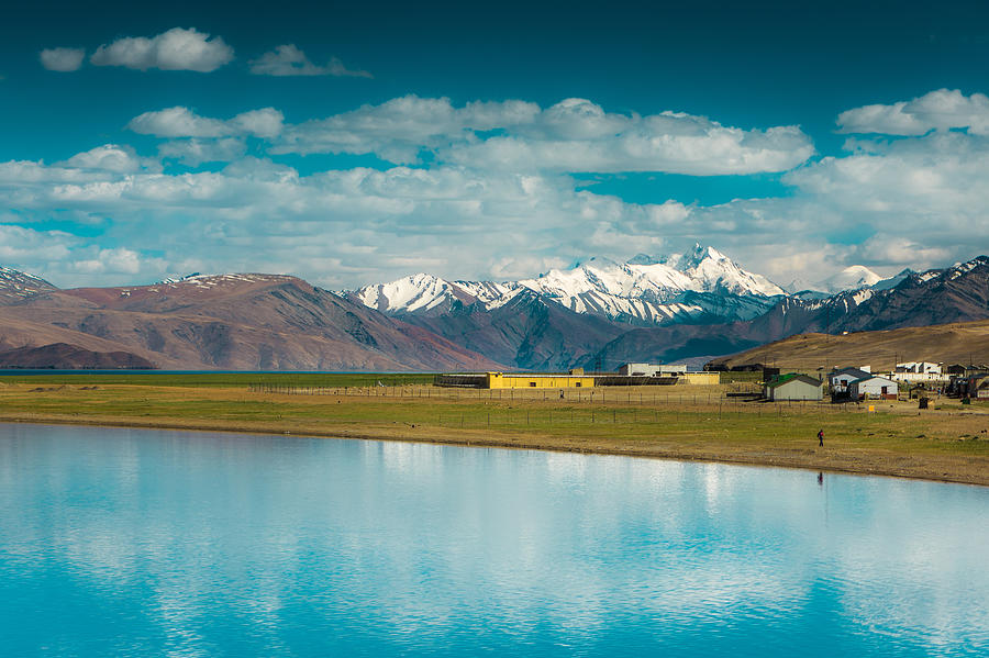 Water Reflection of town and mountain view from Tsomoriri Lake, Leh ladakh, India Photograph by Phongsiri Kittikamhaeng