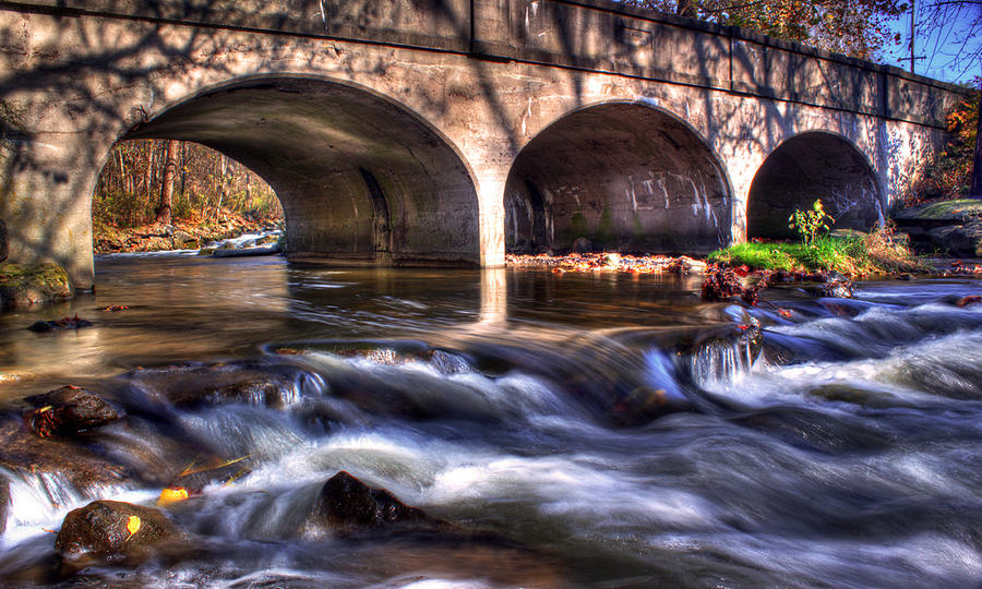 Water under bridge Photograph by Tim Buisman