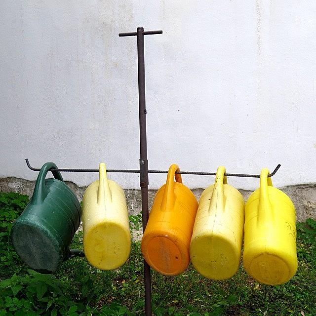 Watering Cans In A Village Cemetery In Photograph by Gia Marie Houck