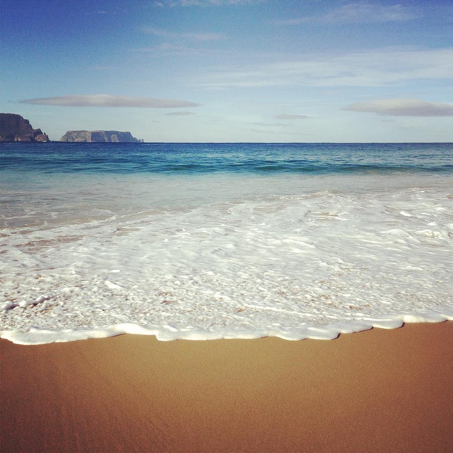 Waves Washing Onto Sand At Secluded Bay Photograph by Jodie Griggs