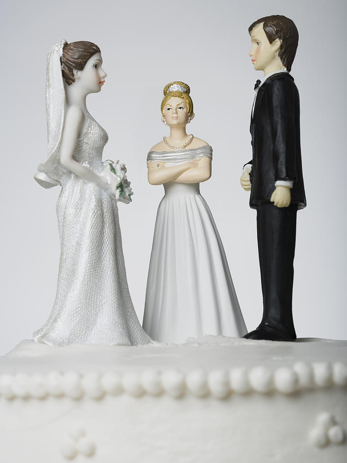 Wedding cake visual metaphor with figurine cake toppers Photograph by Mike Kemp