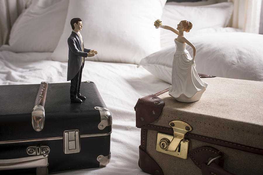 Wedding figurines on separate suitcases Photograph by David Cleveland