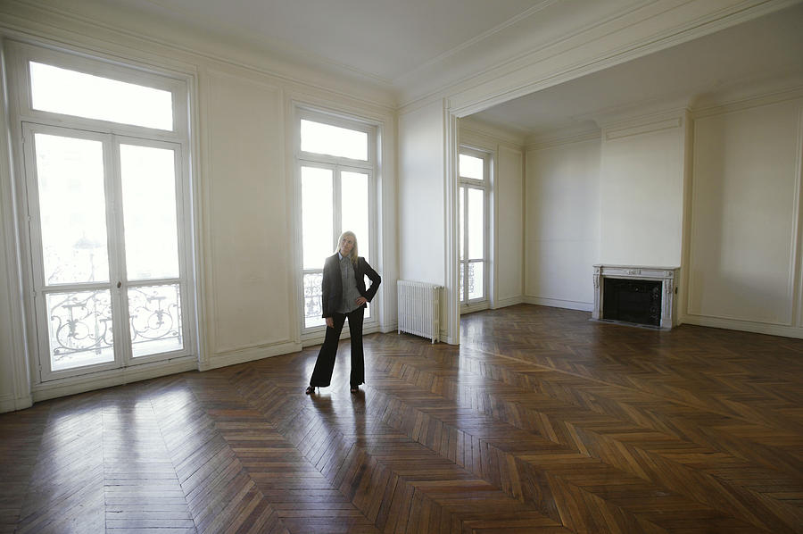 Well Dressed Woman Standing in a Large Empty Room with a Wooden Floor Photograph by B2M Productions