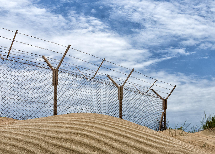 Barbed wire on a sandy beach Photograph by Mike Santis