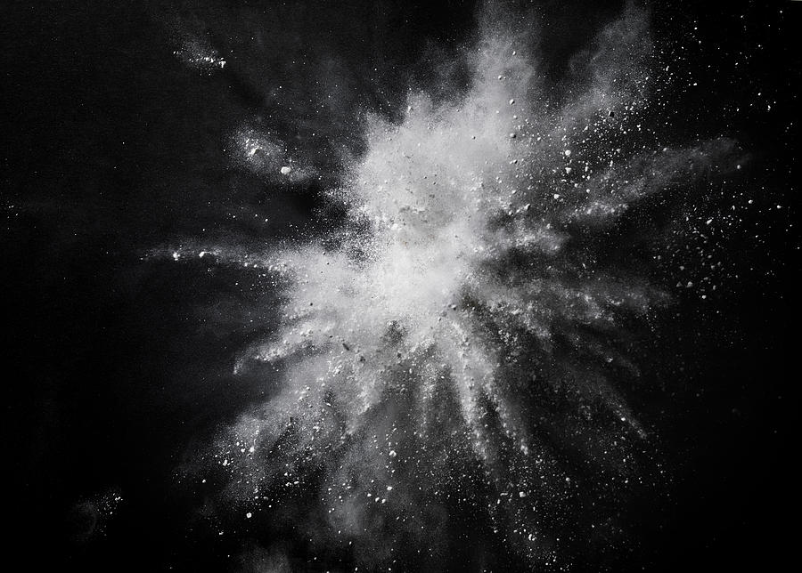 White dust exploding mid air against black background Photograph by Bruno Gori
