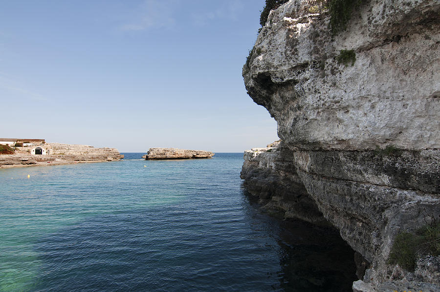 Minorca south coast rocks in Alcafar beach rounded with a turquoise mediterranean sea - White rock Photograph by Pedro Cardona Llambias