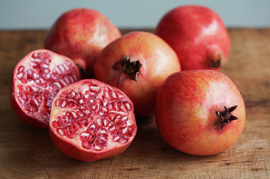 Whole And Halved Pomegranates Photograph by Danielle Wood