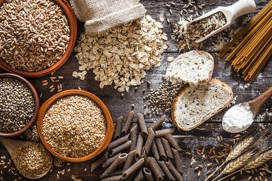Wholegrain food still life shot on rustic wooden table Photograph by Fcafotodigital