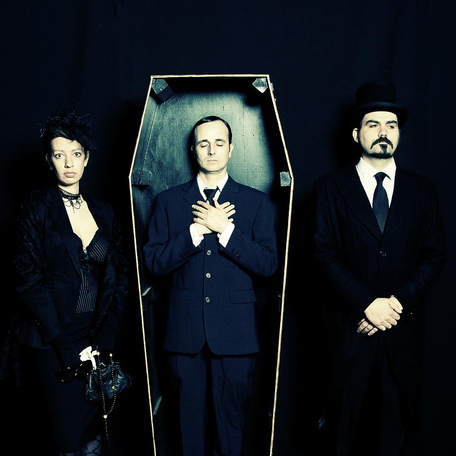 Widow, undertaker and man in coffin Photograph by ProjectB
