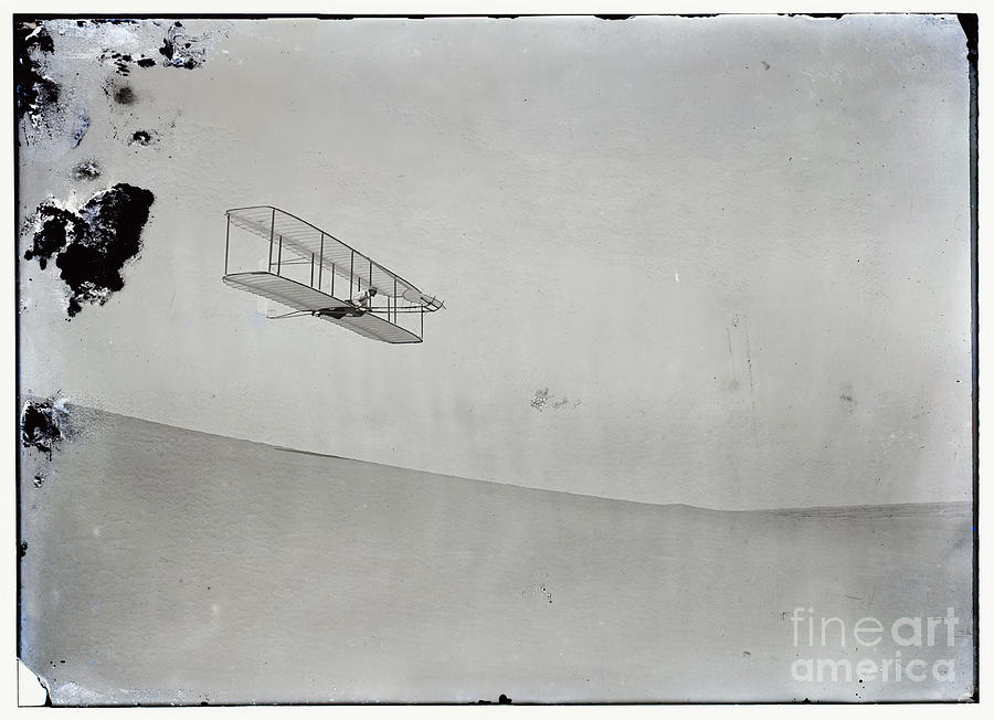 The Wright Brothers Wilbur gliding down steep slope of Big Kill Devil Hill Photograph by Vintage Collectables