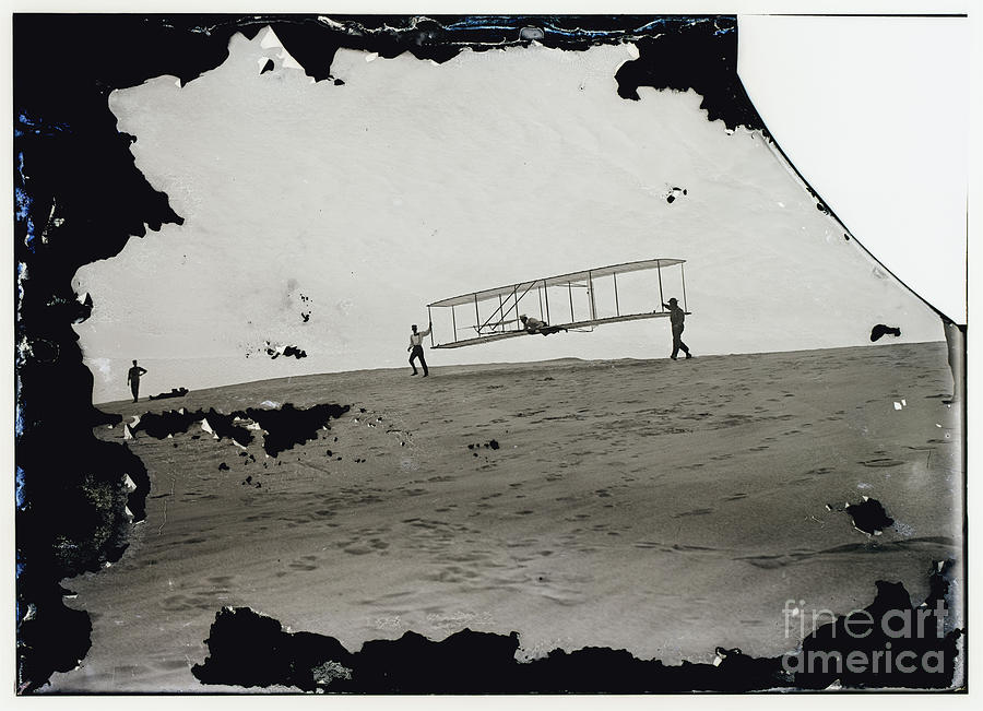 The Wright Brothers Wilbur in motion at left holding one end of glider Photograph by Vintage Collectables