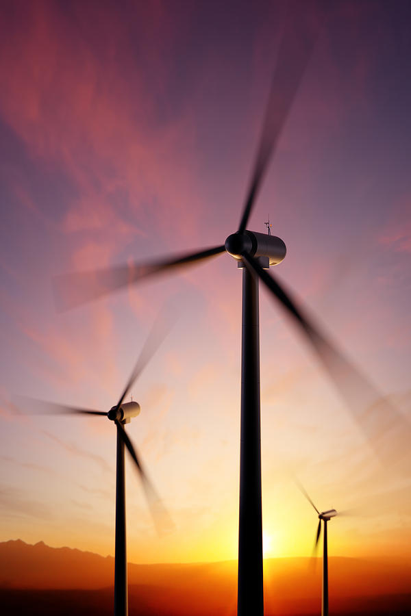 Sunset Photograph - Wind Turbine blades spinning at sunset by Johan Swanepoel