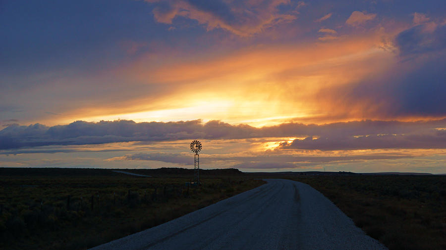 Windmill at Sunset on Dirt Road Photograph by Daniel Woodrum