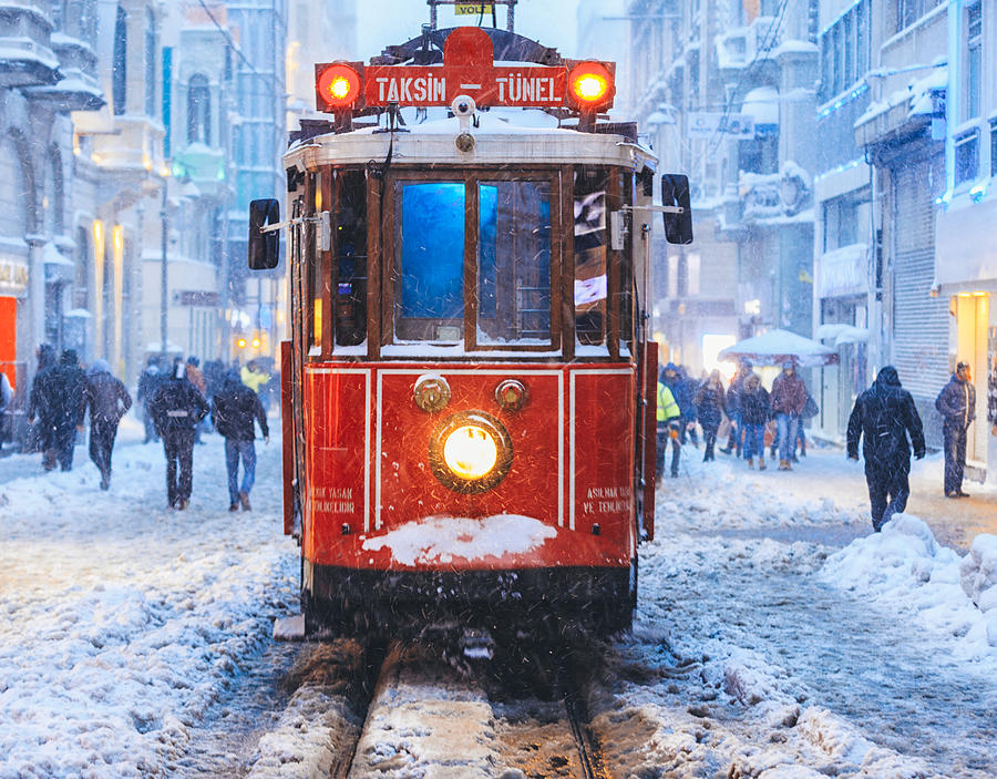 Winter and Red Tram in Istiklal Street, Beyoglu, Istanbul. Photograph by Sami Sert