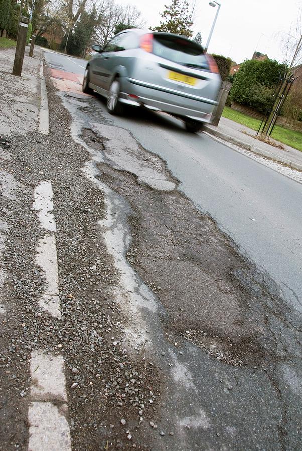 Transportation Photograph - Winter Potholes And Passing Car by Trl Ltd./science Photo Library