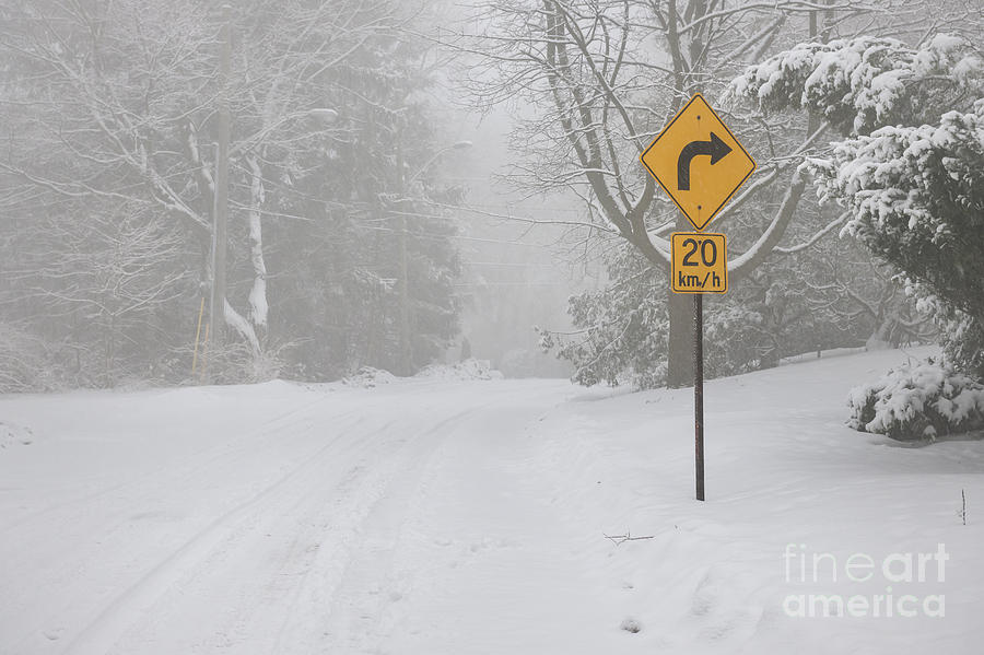 Winter road with yellow sign Photograph by Elena Elisseeva